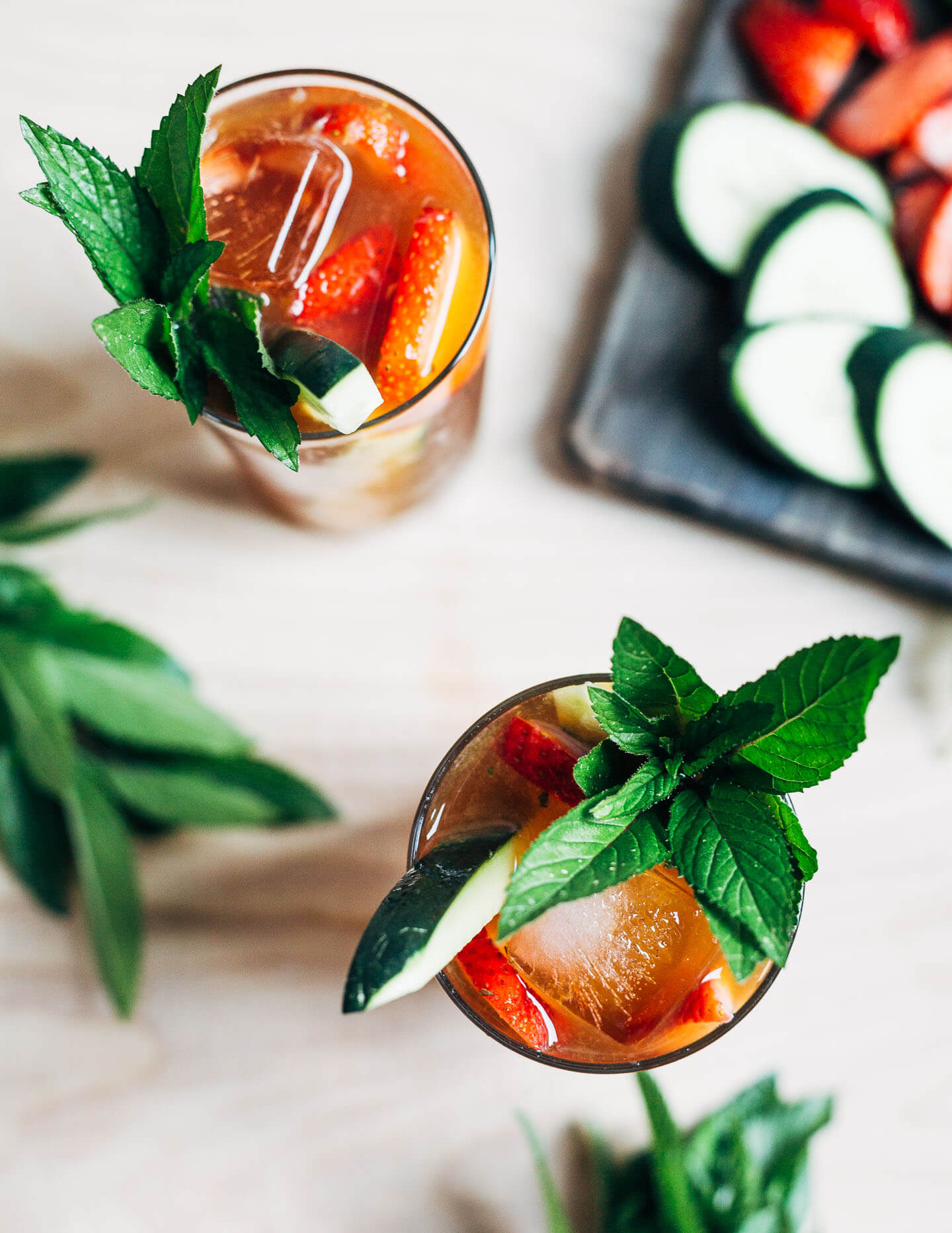 Classic Pimm's cup cocktails for your summer celebrations. Made with strawberries, cucumbers, tarragon, mint, and fresh lime, these Pimm's cups are the perfect lower-alcohol summer sip.