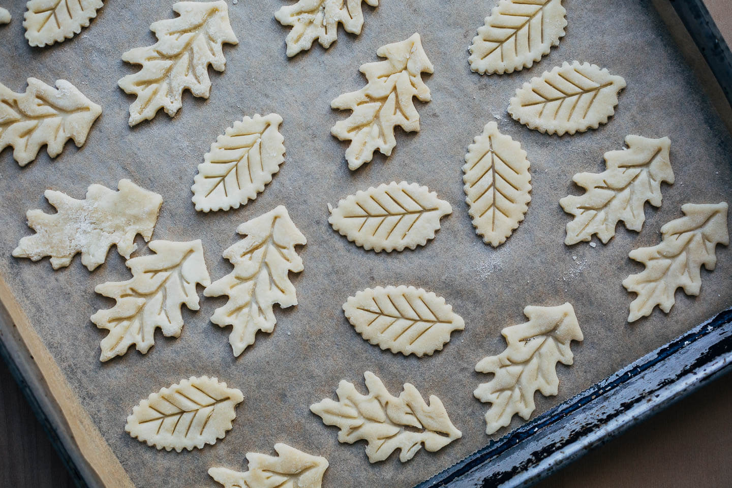 Decorative leaf cutouts on a baking sheet