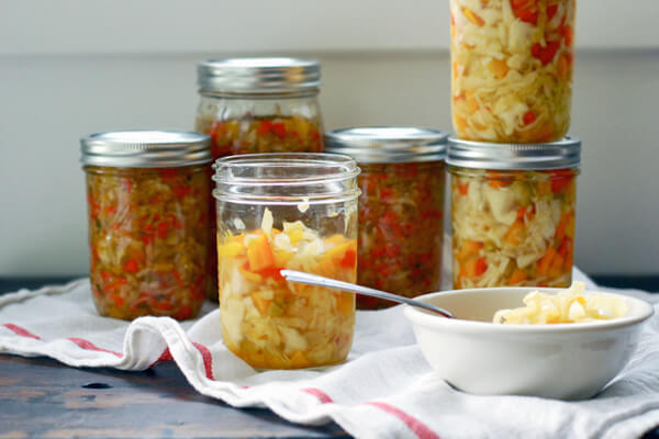 Several jars of chowchow and a bowl of chowchow alongside. 