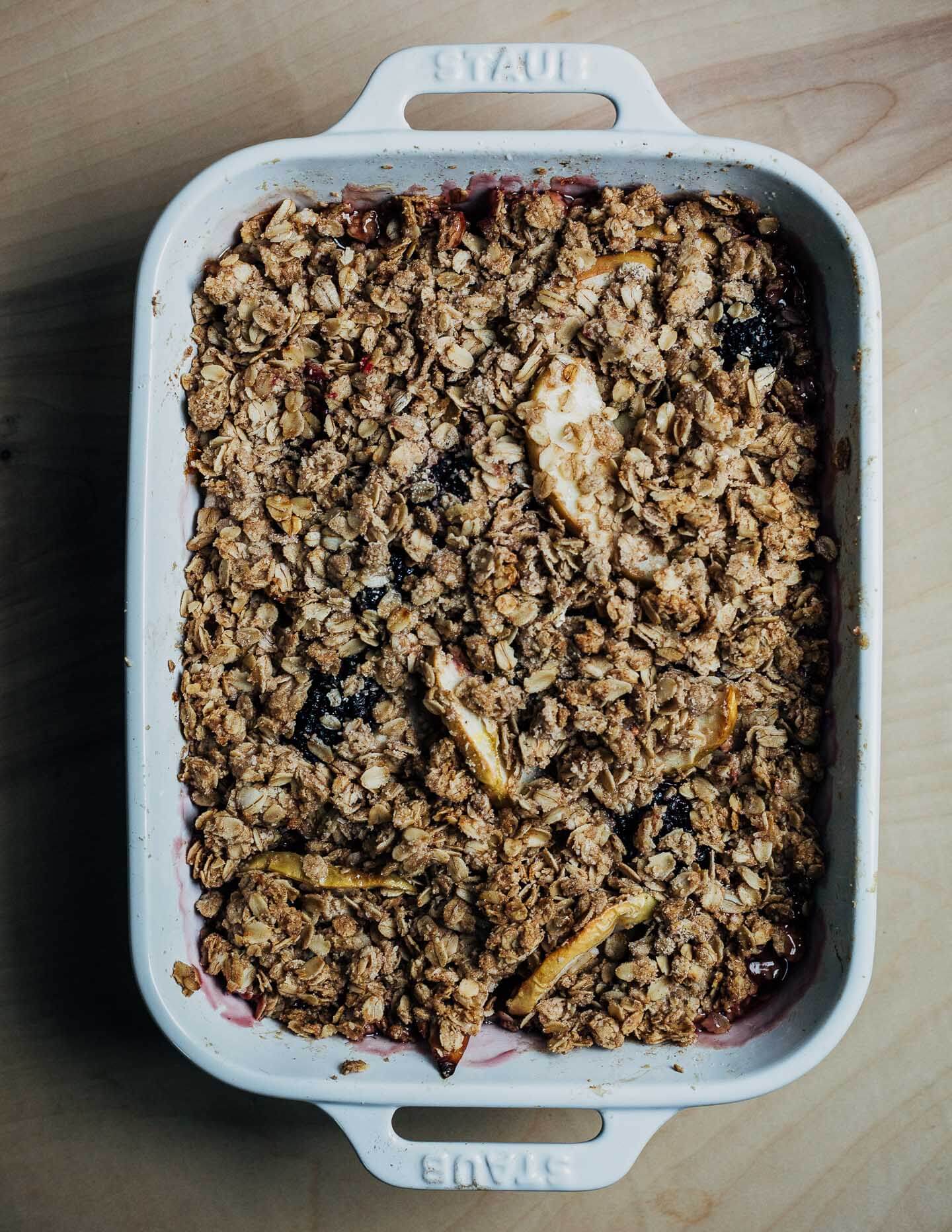 A baking dish with a baked blackberry-apple crisp. 