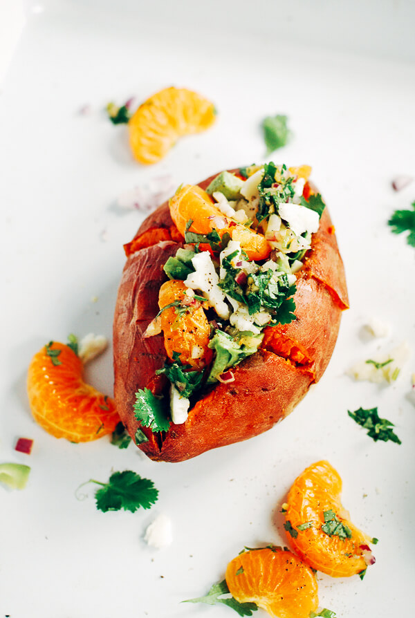A decadent yet healthy loaded sweet potato recipe that's topped with tangelos, avocado, and haloumi.