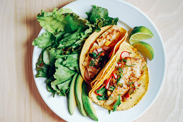 Savory pacific cod fish tacos topped with a sweet and spicy heirloom tomato and peach salsa.