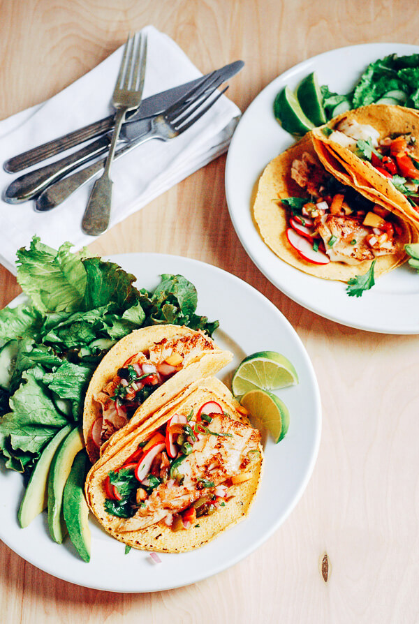 Savory pacific cod fish tacos topped with a sweet and spicy heirloom tomato and peach salsa.