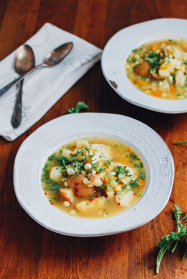 Two bowls of corn chowder on a table. 