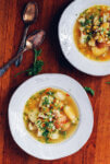 Two bowls of corn chowder on a table.