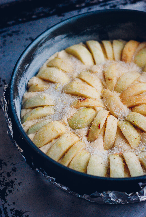 A buttermilk apple cake, with sliced apples tucked into the top, ready to bake. 