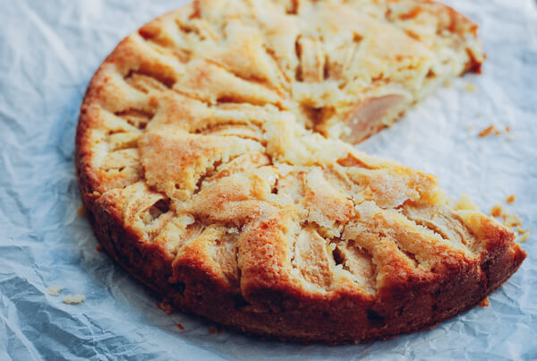 An apple cake with two slices taken out.