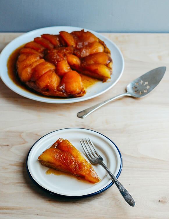 A plated tarte tatin alongside a slice on a plate. 