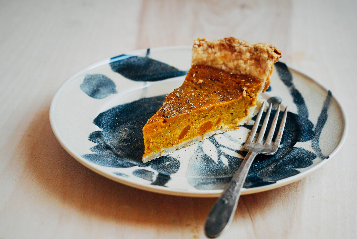 A creative twist on a classic pumpkin pie recipe, this kabocha squash pie is flecked with chipotle chili powder, black pepper, and fresh ginger.