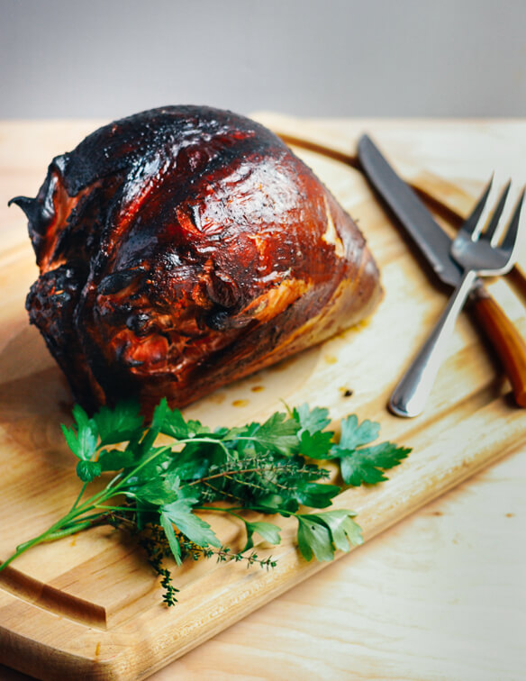 A smoked turkey breast on a cutting board. 