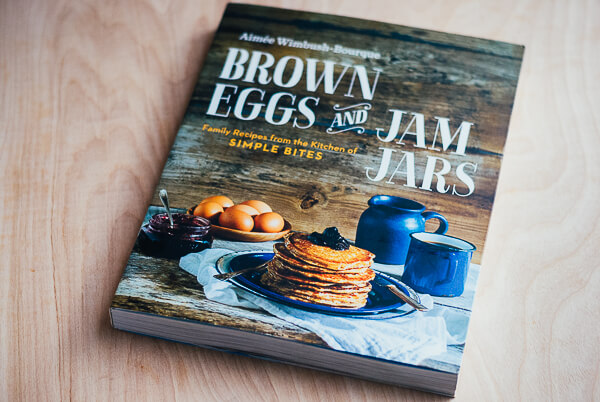 A cookbook called "Brown Eggs and Jam Jars is lying on a table. 