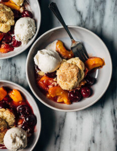 Bowls filled with cherry and peach cobbler