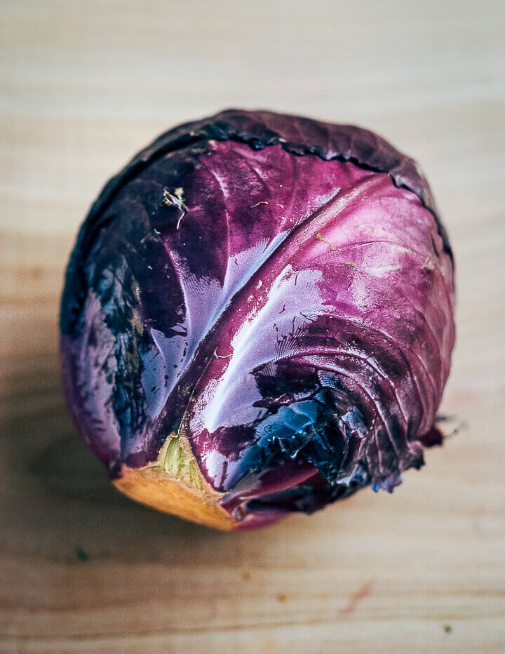 A red cabbage sitting on the counter.