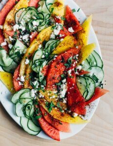 A plate with a pretty cucumber and watermelon salad