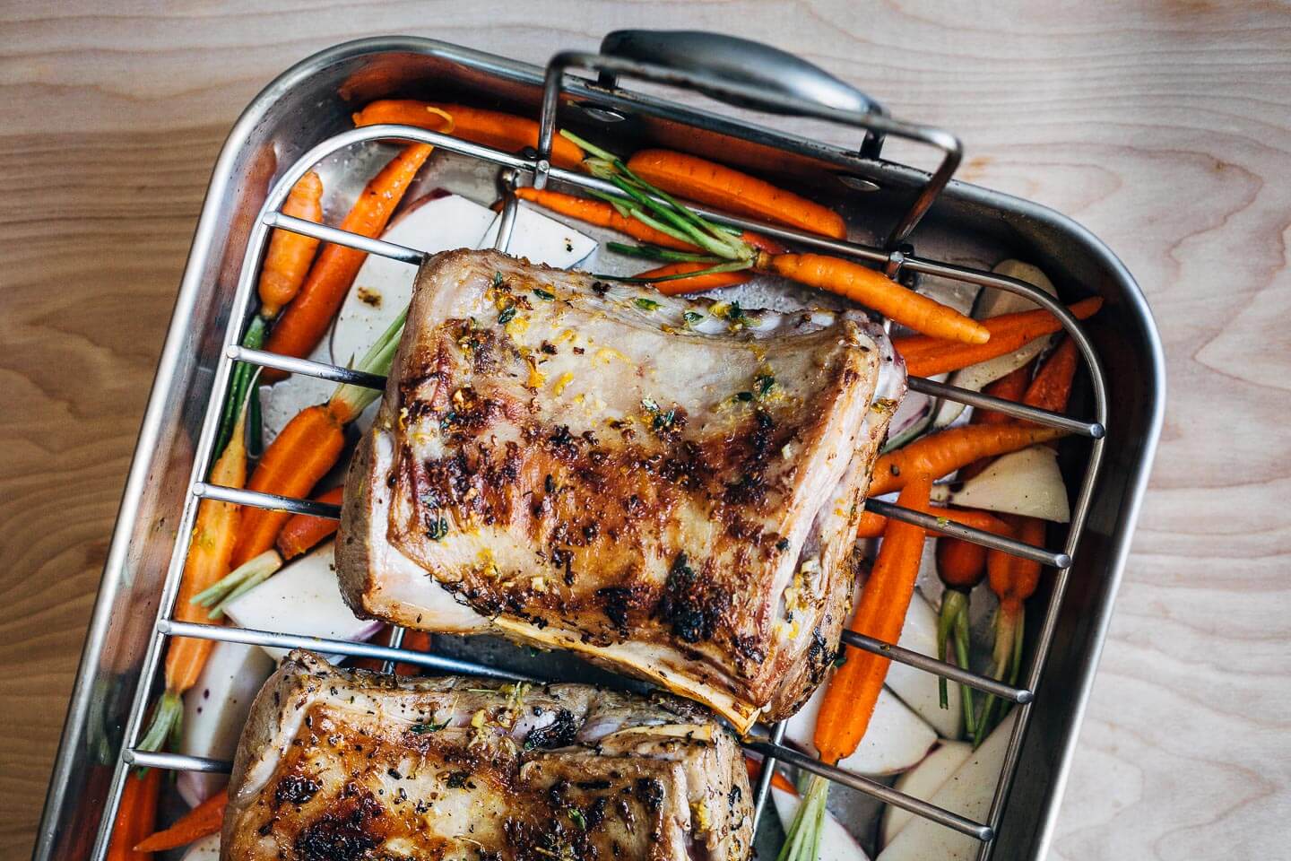 A dinner party-worthy recipe for rack of lamb roasted alongside root vegetables and served with a vibrant honey orange sauce.
