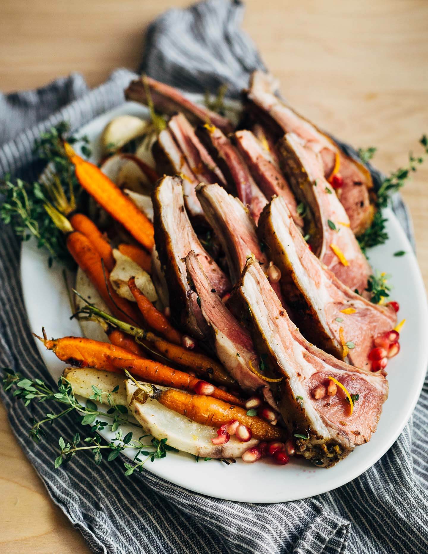 A dinner party-worthy recipe for rack of lamb roasted alongside root vegetables and served with a vibrant honey orange sauce.