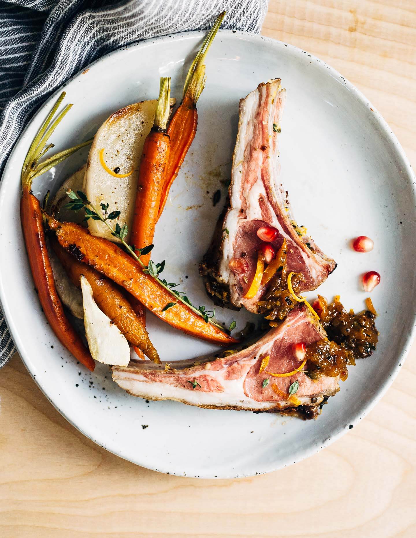 A dinner party-worthy recipe for rack of lamb roasted alongside root vegetables and served with a vibrant honey orange sauce.