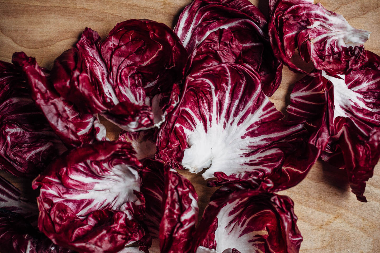 An autumnal radicchio and roasted delicata squash salad tossed in a lemon maple dressing, and topped with salty pepitas, fried sage leaves, and Parmesan.