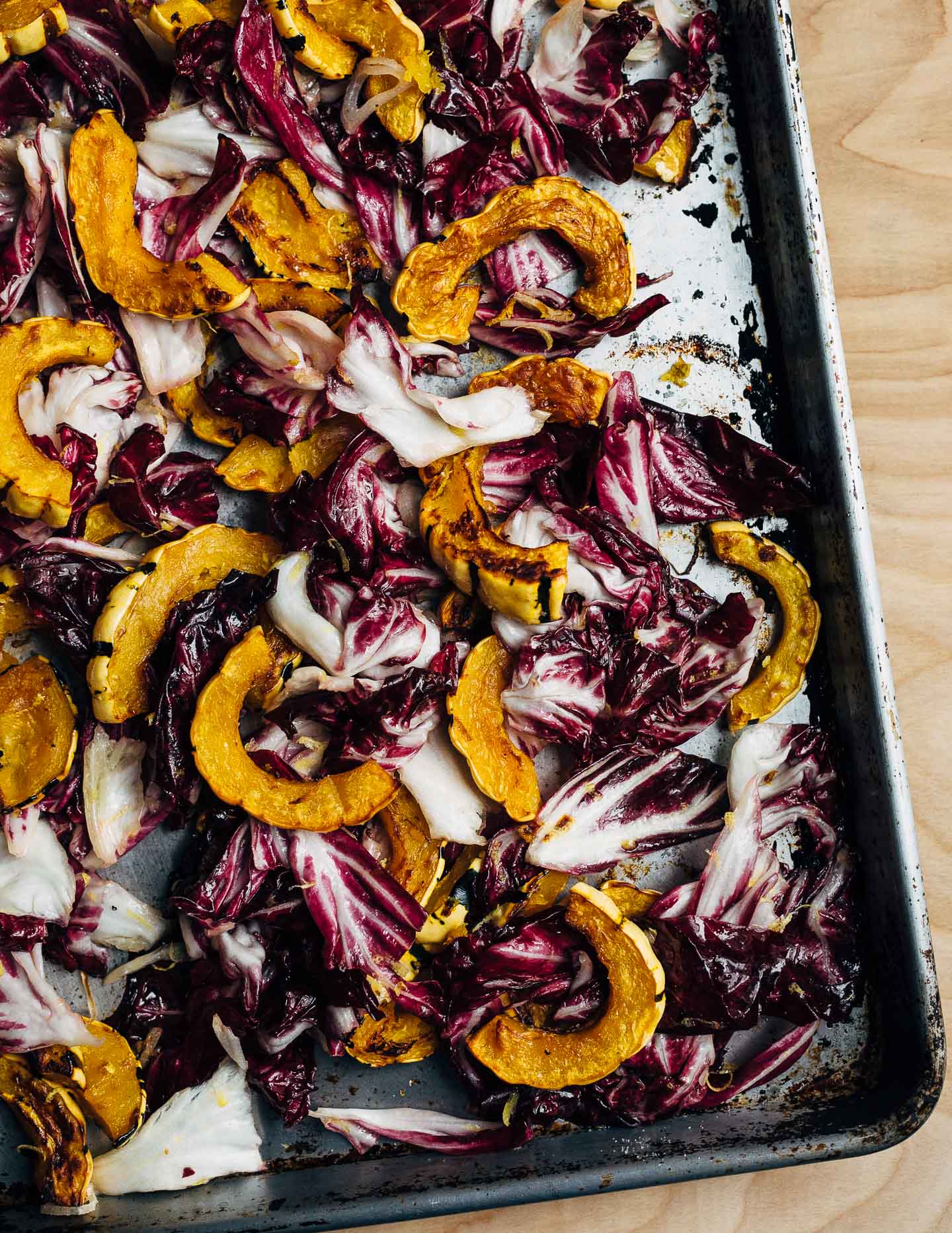 An autumnal radicchio and roasted delicata squash salad tossed in a lemon maple dressing, and topped with salty pepitas, fried sage leaves, and Parmesan.