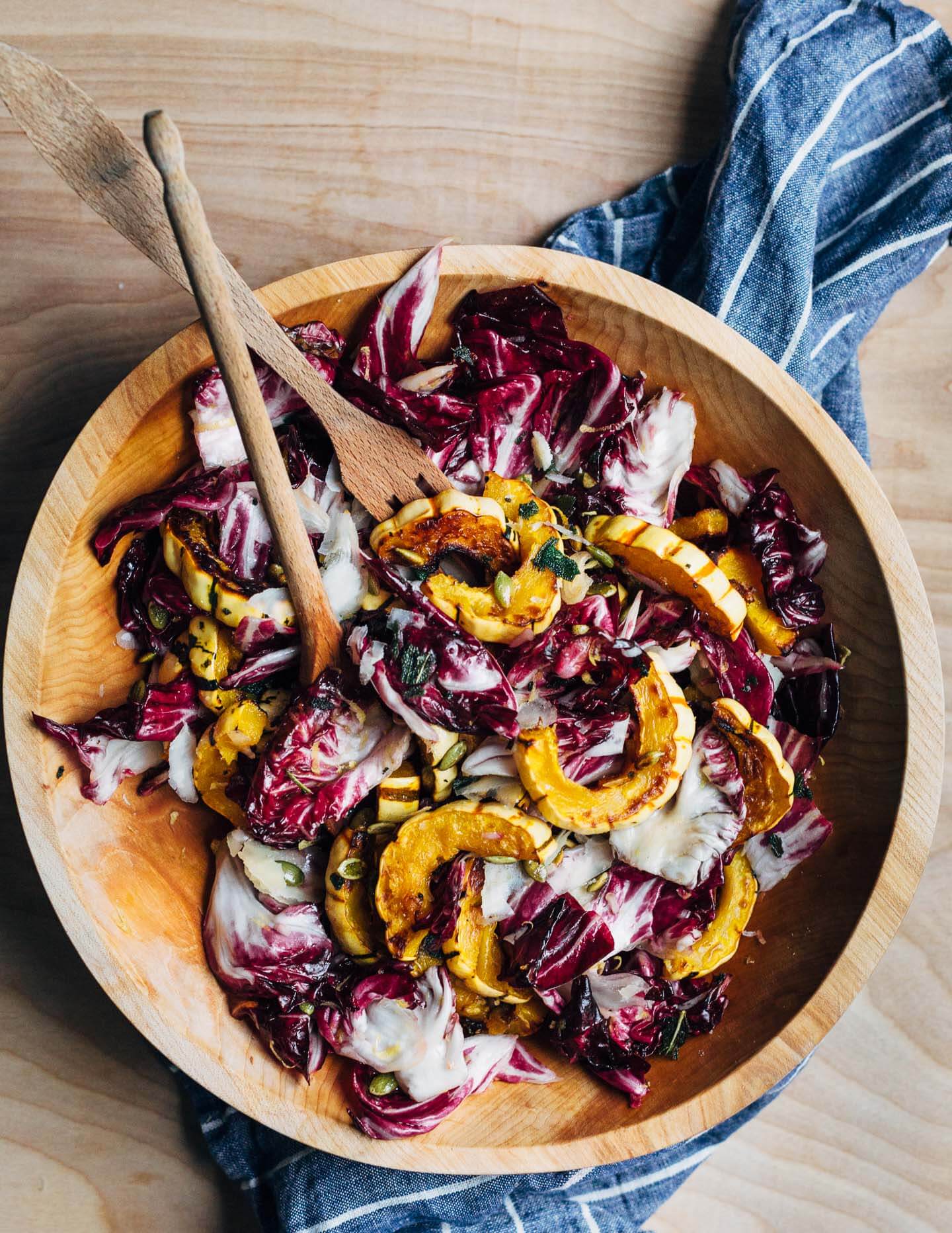 An autumnal radicchio and roasted delicata squash salad tossed in a lemon maple dressing, and topped with salty pepitas, crisp sage leaves, and Parmesan.