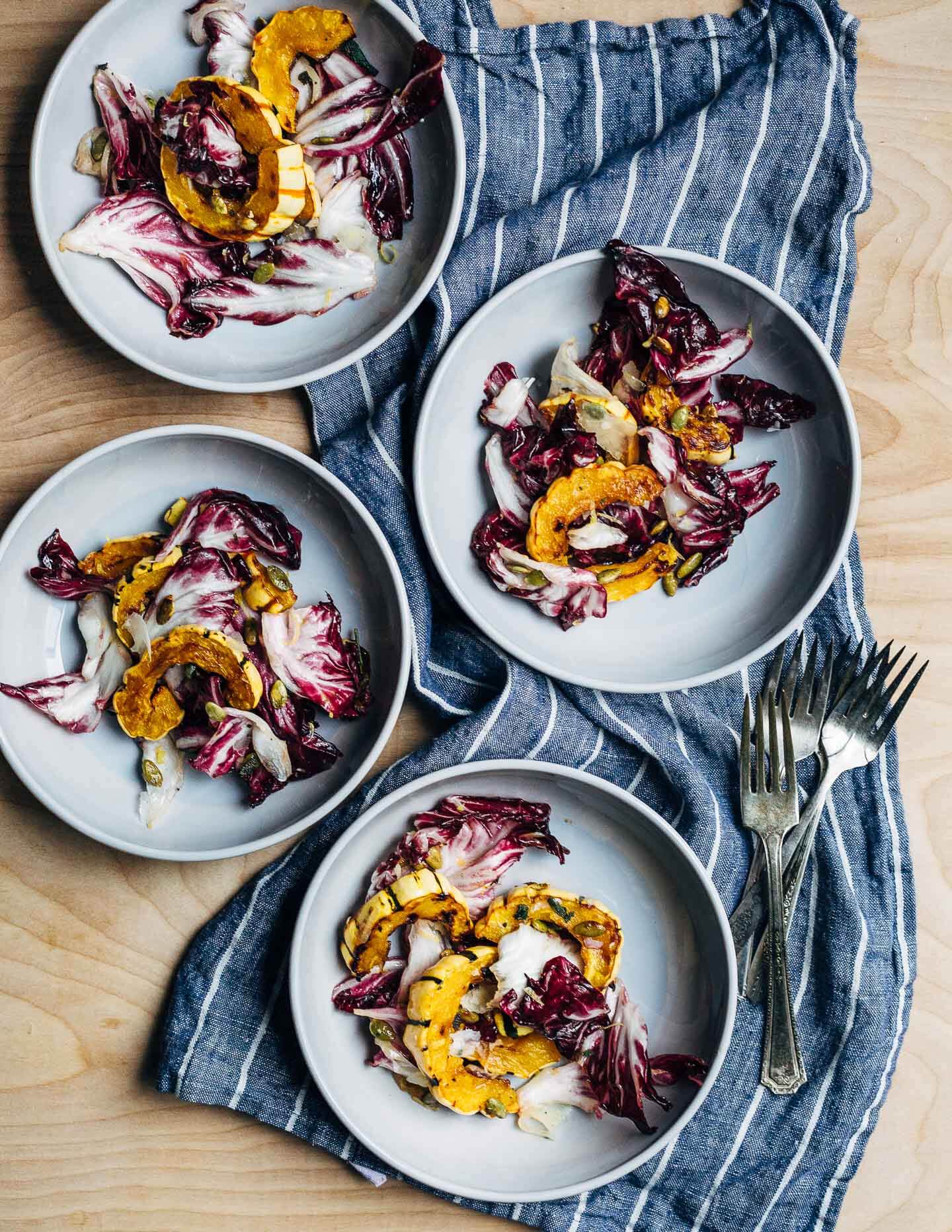 An autumnal radicchio and roasted delicata squash salad tossed in a lemon maple dressing, and topped with salty pepitas, fried sage leaves, and Parmesan.