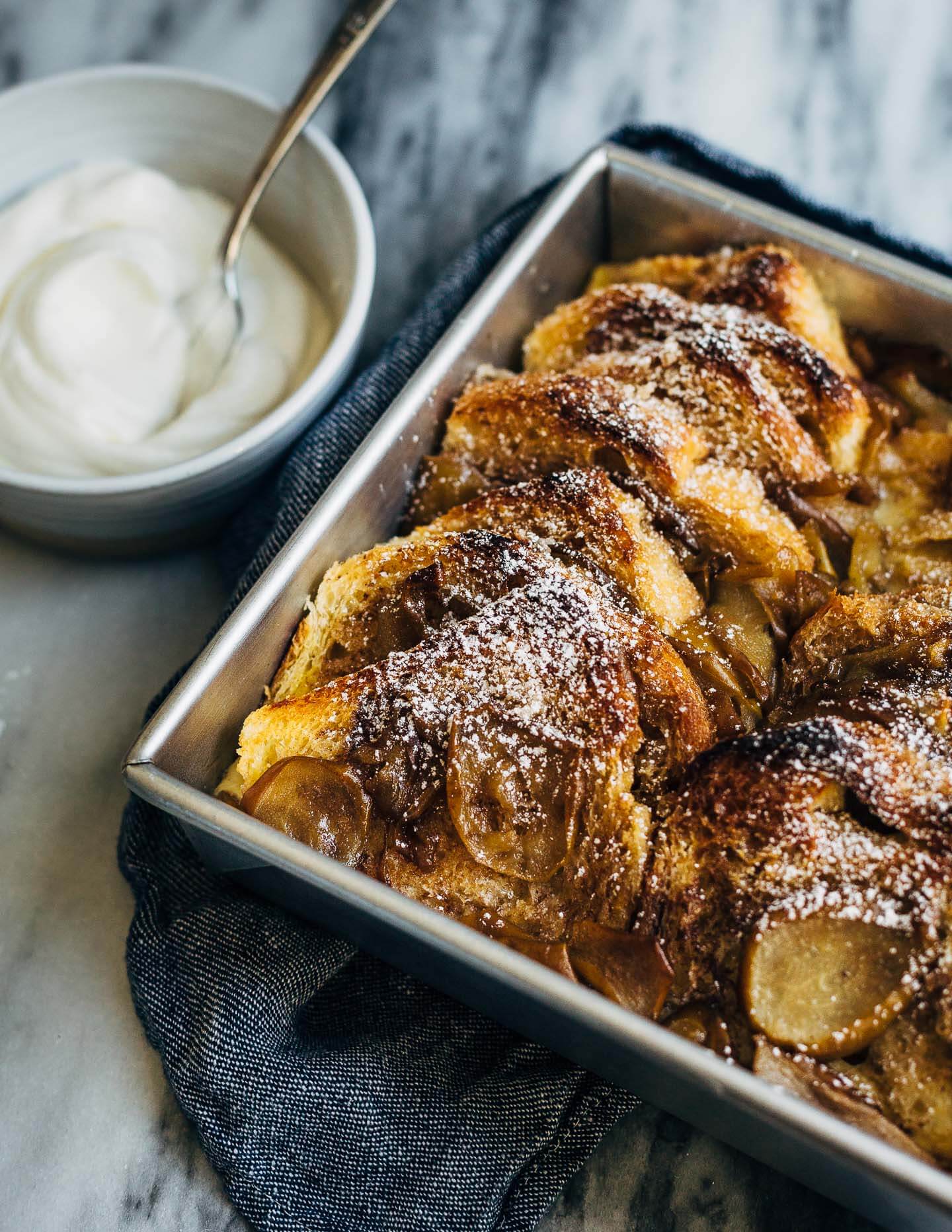 Seckel pears sautéed in brown butter syrup and slices of brioche dipped in cinnamon sugar elevate this simple seckel pear bread pudding recipe. 