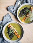 Nourishing green soup with creamy coconut milk and wild rice topped with a pan-seared salmon fillet.