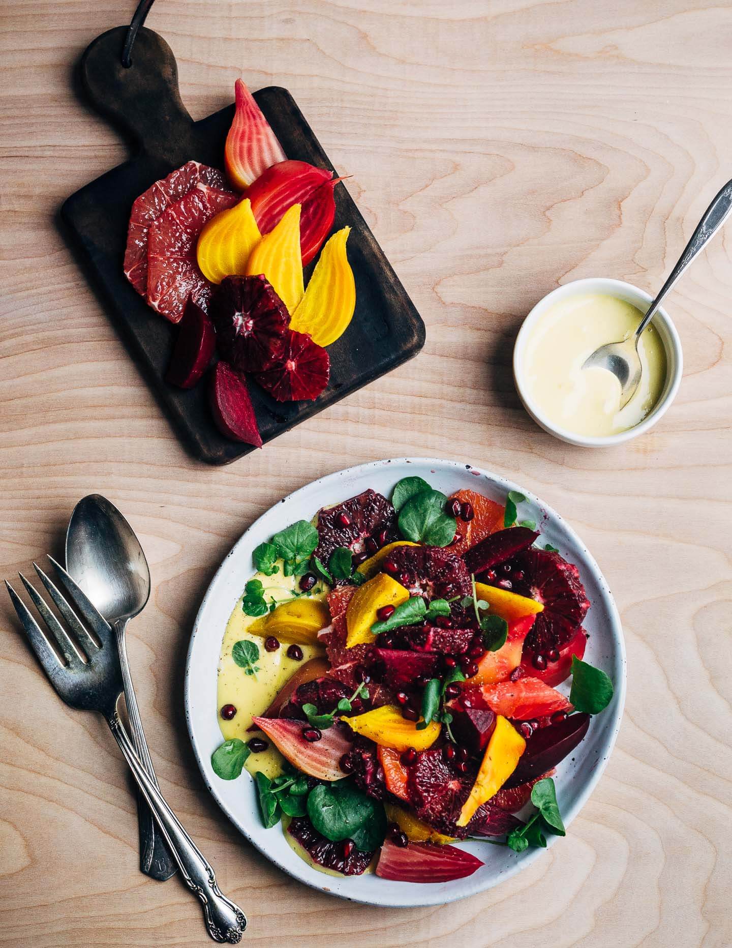 A jewel-toned winter orange and beet salad with layers of Cara Cara and blood oranges, grapefruit segments, red, yellow and chioggia beets, and a creamy homemade grapefruit aioli. 