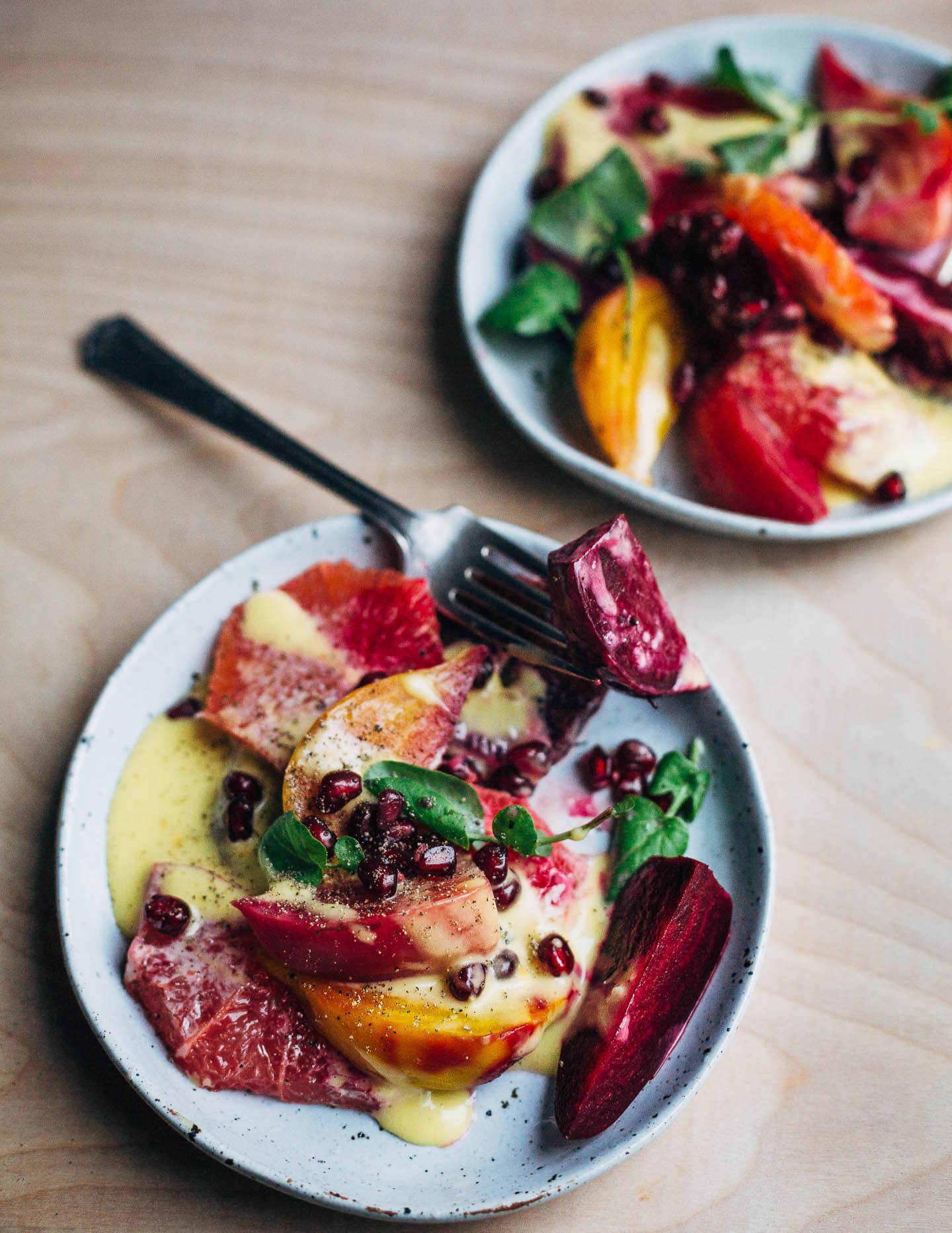 A jewel-toned winter orange and beet salad with layers of Cara Cara and blood oranges, grapefruit segments, red, yellow and chioggia beets, and a creamy homemade grapefruit aioli. 