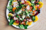 A wintry orange and arugula salad scattered with citrus-marinated radishes and drizzled with creamy buttermilk ranch dressing.