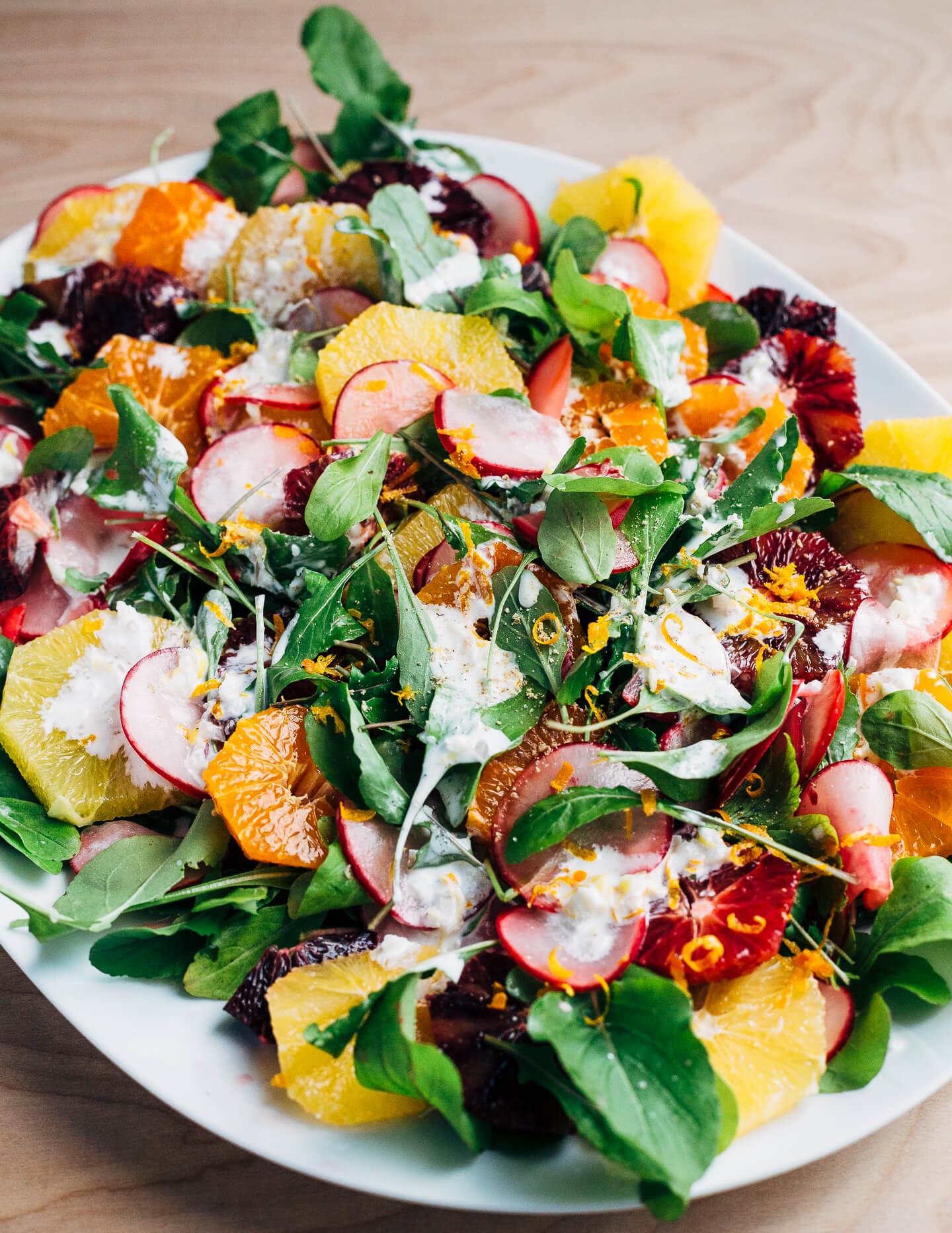 A wintry orange and arugula salad scattered with citrus-marinated radishes and drizzled with creamy buttermilk ranch dressing.