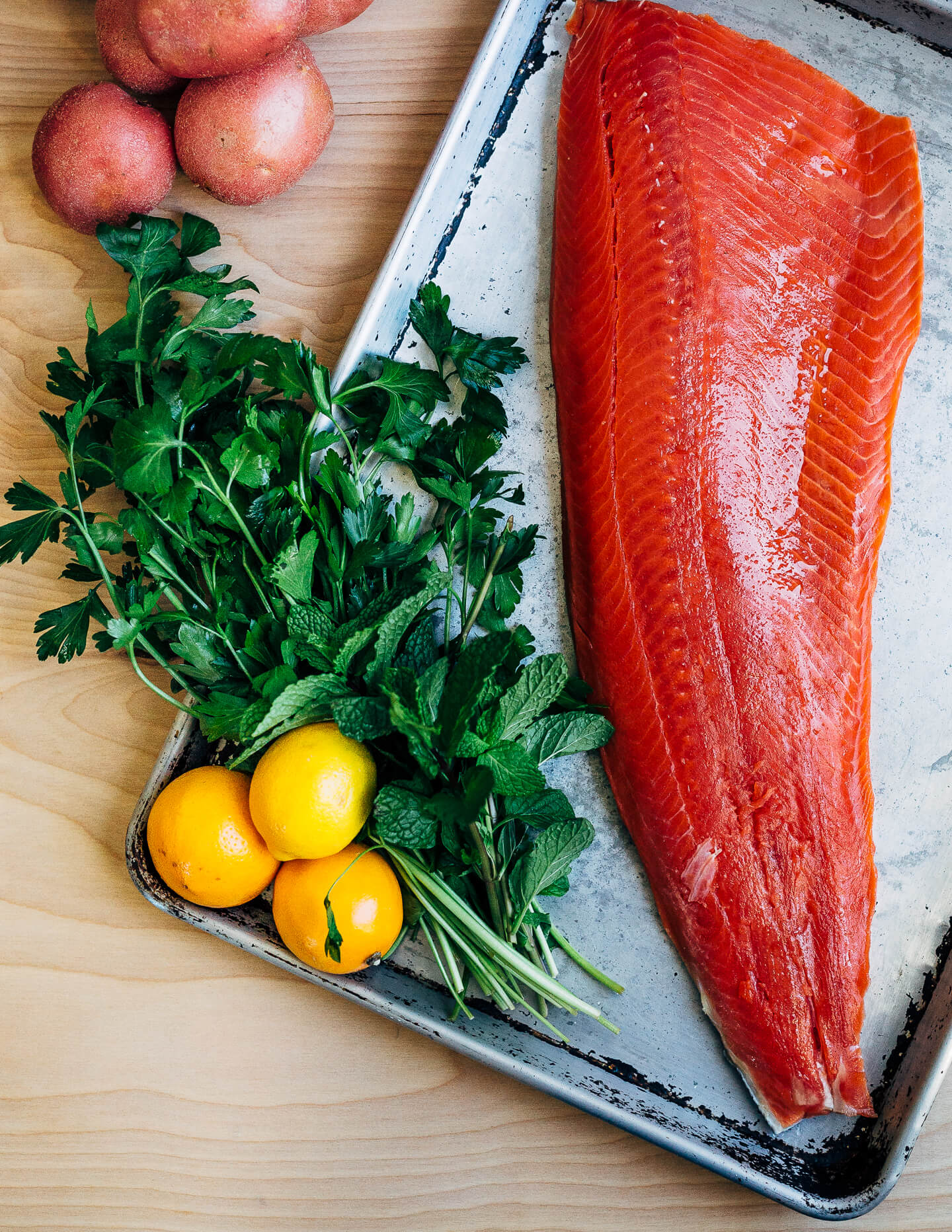 Broiled salmon fillets with a vibrant Meyer lemon and mint chimichurri makes for a simple, yet elevated mid-winter meal that's perfect for a Valentine's dinner at home. 