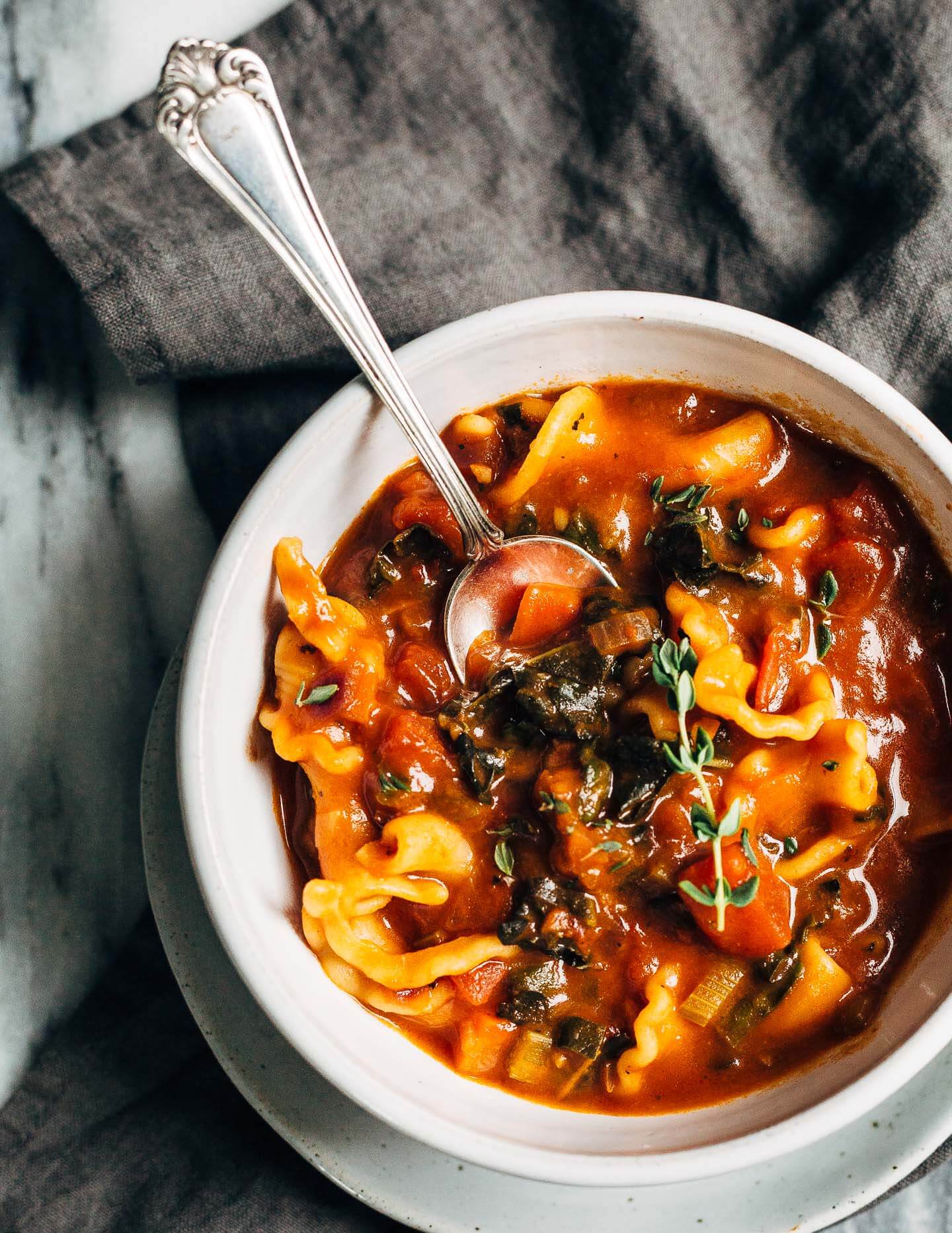 A meal-worthy vegan vegetable pasta soup with a little bit of everything: delicious vegetable broth, fire-roasted tomatoes, kale, carrots, thyme, and toothsome pasta.