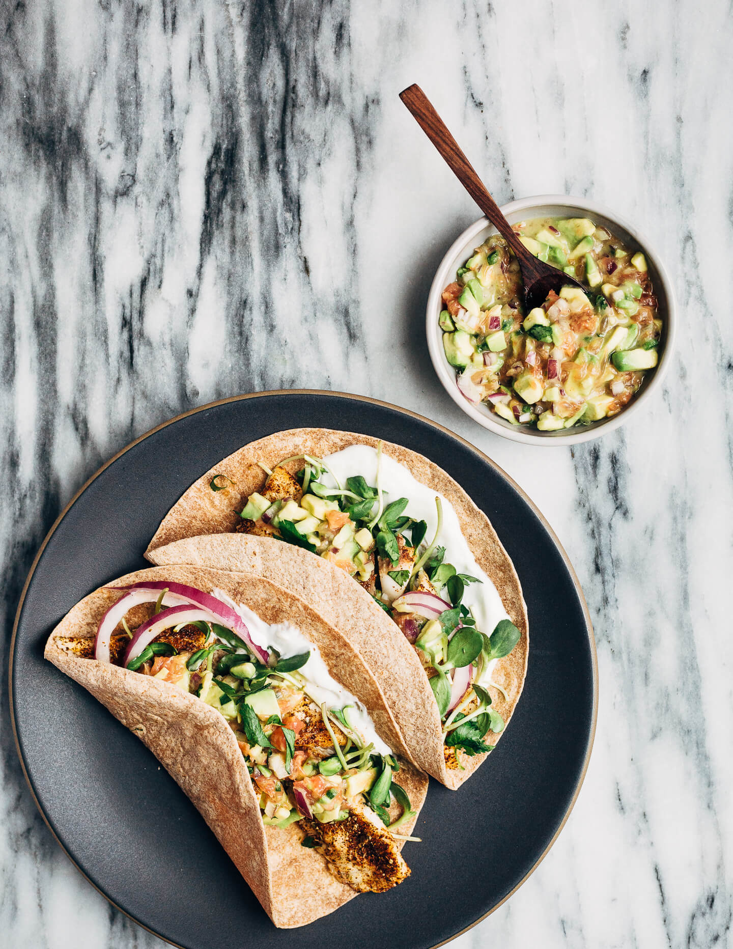 Simple broiled tilapia tacos that come together quickly under the broiler, making them perfect for weeknight meals. The tacos are topped with a tangly grapefruit-avocado salsa that contrasts beautifully with the spicy fish. 