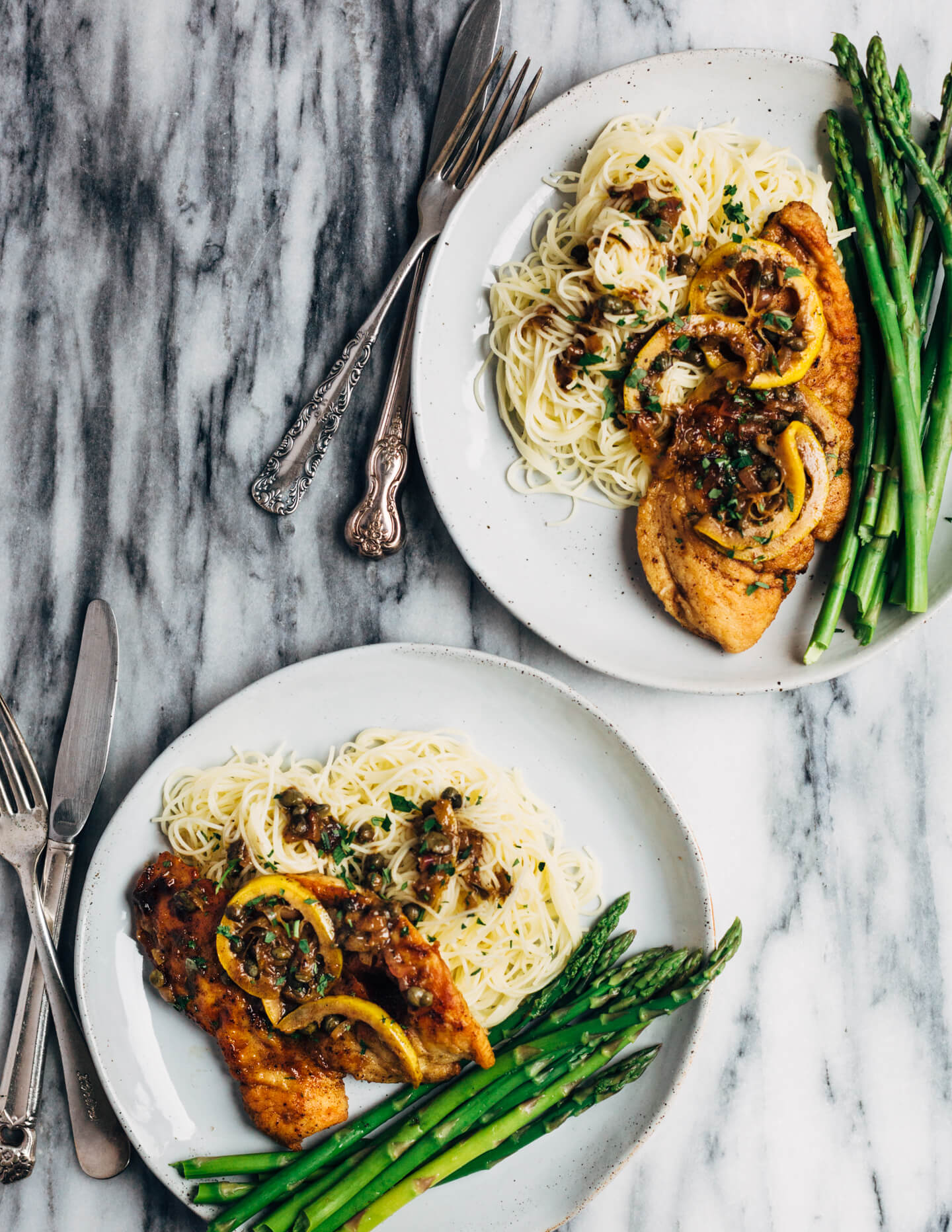 Weeknight-perfect chicken piccata topped with a bright and buttery caper sauce and served alongside angel hair pasta and asparagus.