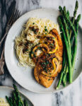 Weeknight-perfect chicken piccata topped with a bright and buttery caper sauce and served alongside angel hair pasta and asparagus.