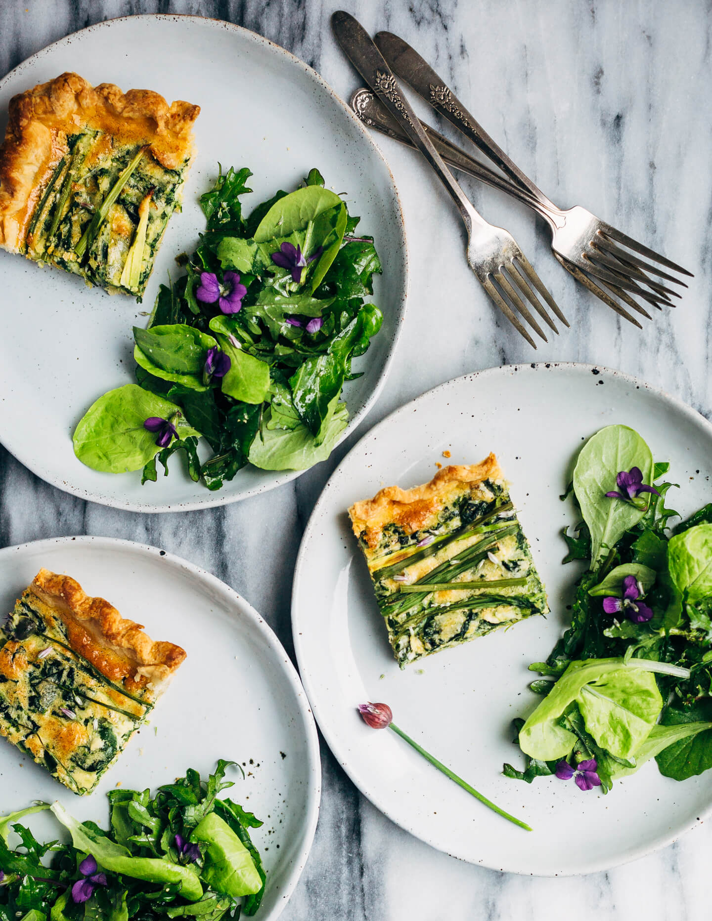 Ideal for Mother's Day brunch or spring gatherings, this sheet pan spinach quiche, made with ramps, green garlic, and chives, is a delicious way to feed a crowd. 