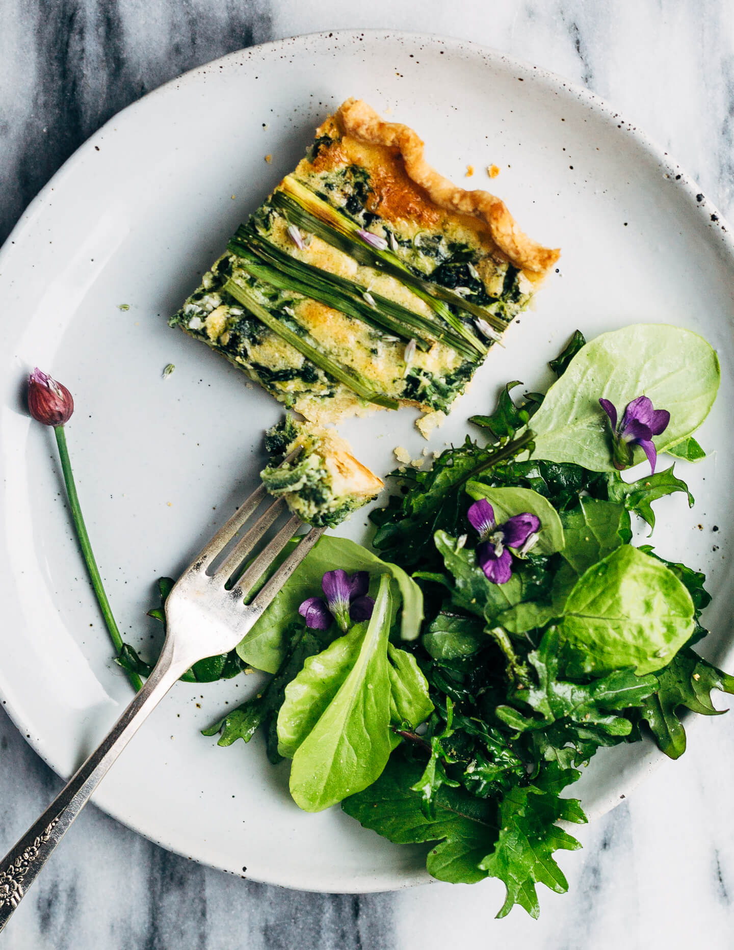 Ideal for Mother's Day brunch or spring gatherings, this sheet pan spinach quiche, made with ramps, green garlic, and chives, is a delicious way to feed a crowd. 