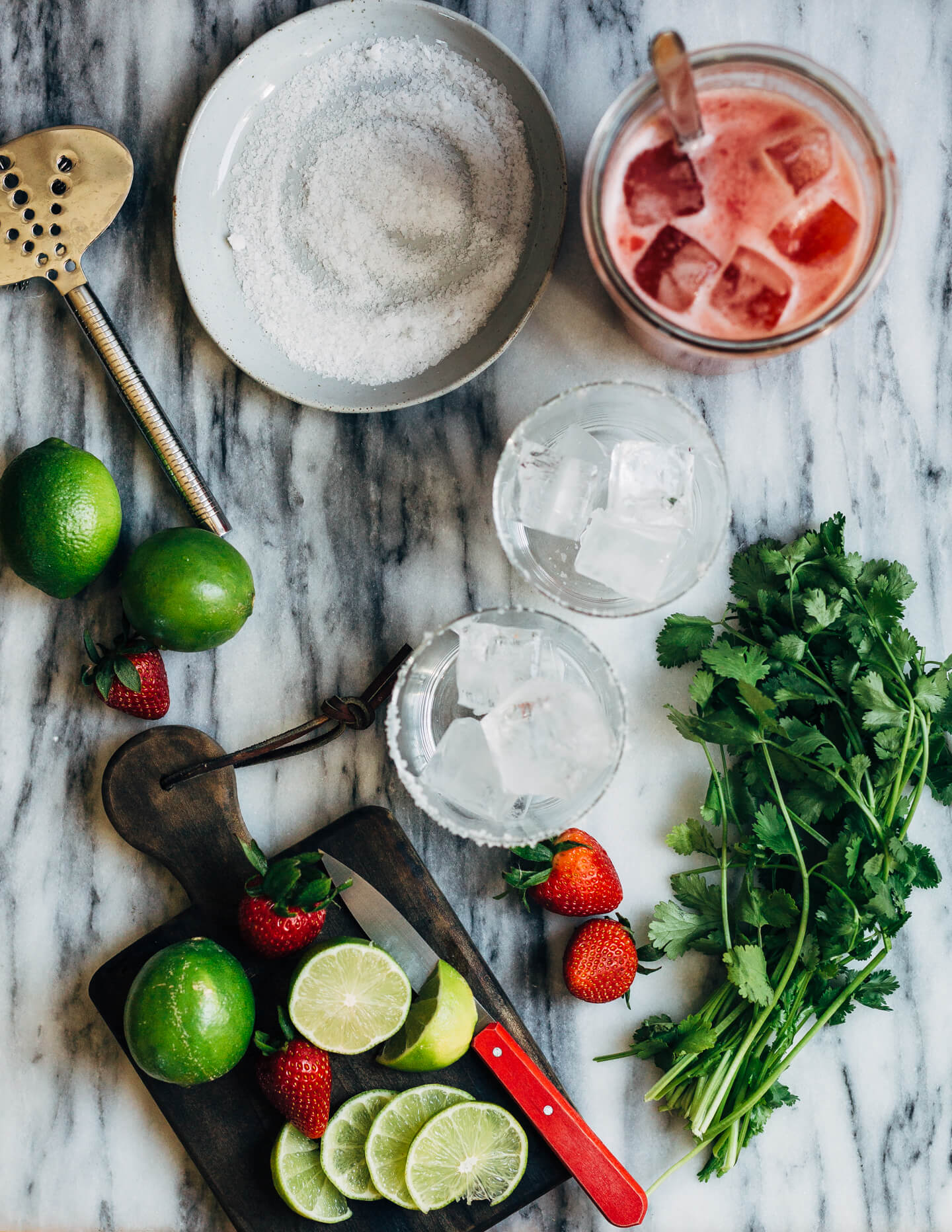 Pretty pink strawberry margaritas blended with an herbaceous cilantro, coriander, and black pepper simple syrup. These fresh strawberry margaritas are beautifully balanced and totally refreshing. 
