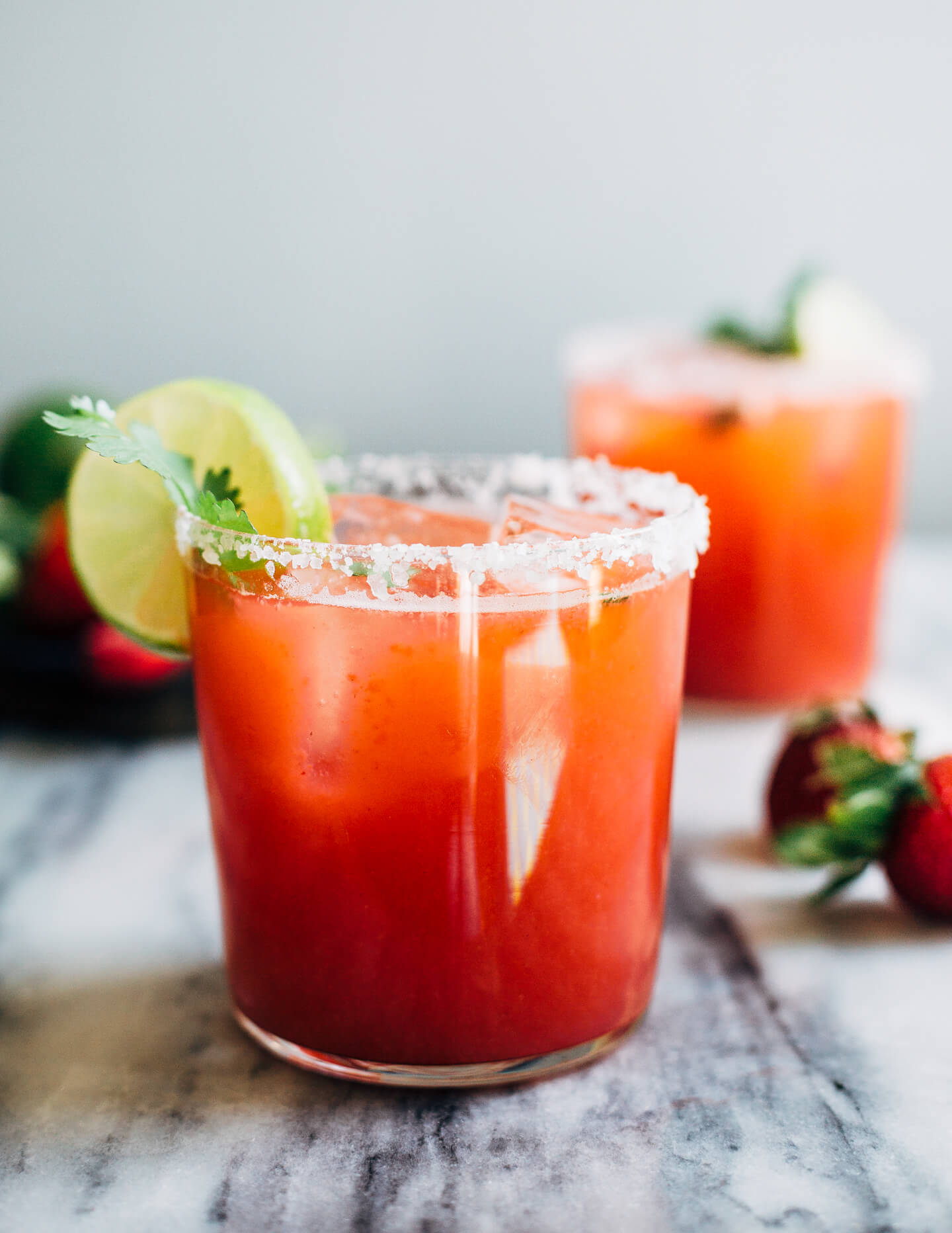 Pretty pink strawberry margaritas blended with an herbaceous cilantro, coriander, and black pepper simple syrup. These fresh strawberry margaritas are beautifully balanced and totally refreshing. 