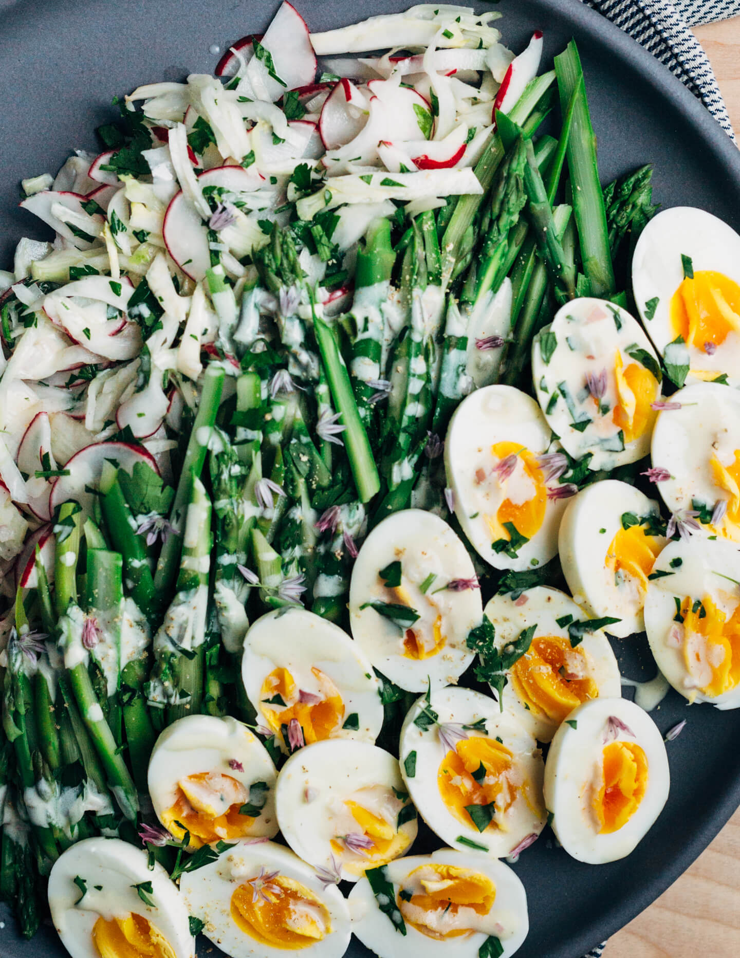 A substantial, spring-inspired fennel, radish, and asparagus salad with creamy buttermilk-lime dressing and steamed hard-boiled eggs. 
