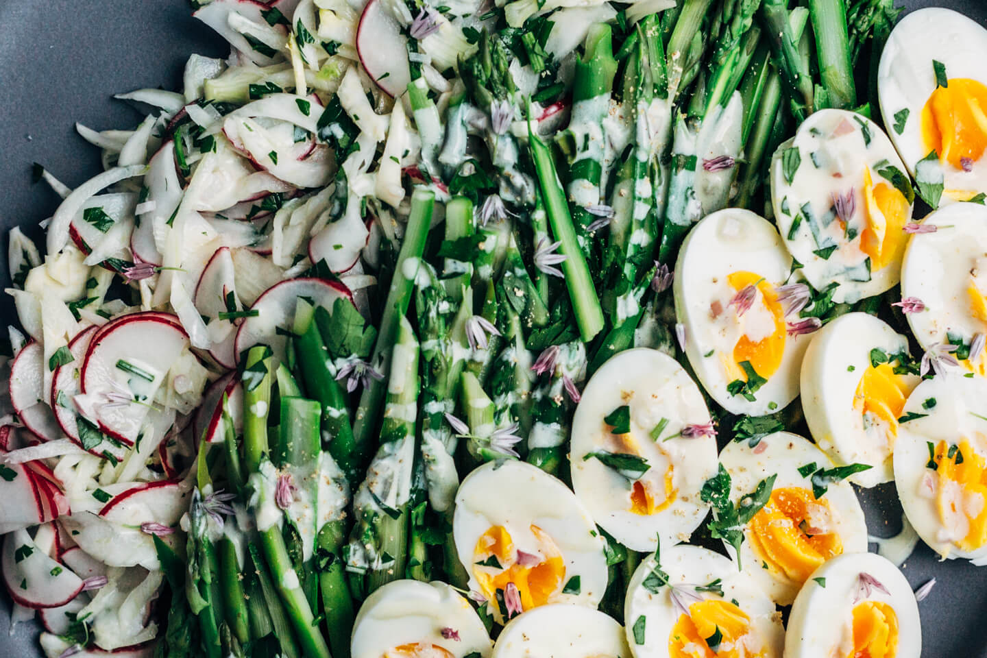 A substantial, spring-inspired fennel, radish, and asparagus salad with creamy buttermilk-lime dressing and steamed hard-boiled eggs. 