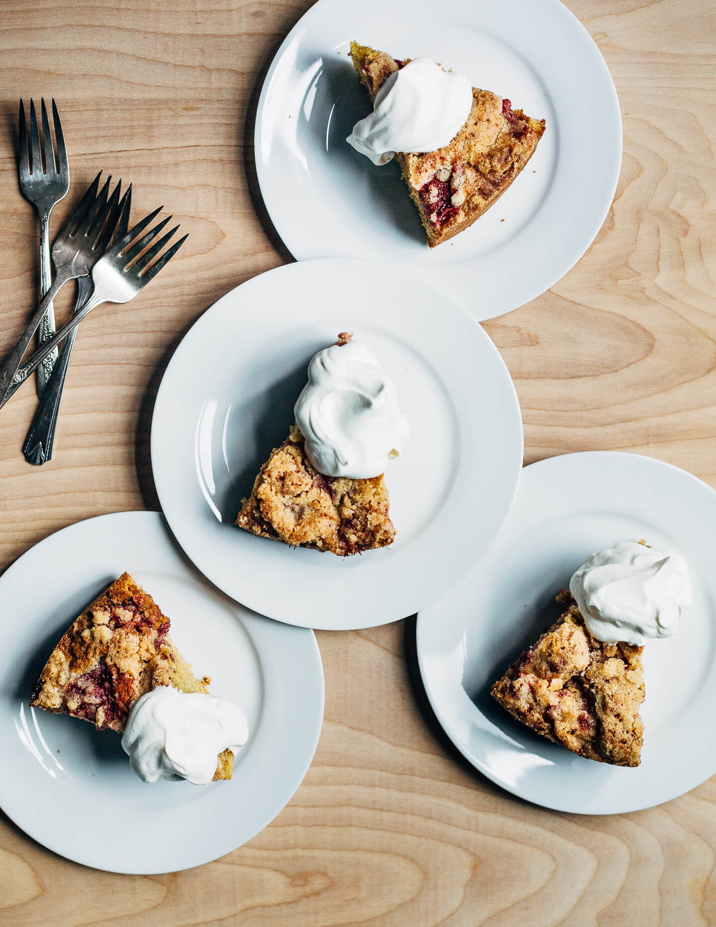 This strawberry crumb cake has a toothsome whole wheat crumb and is topped with ripe strawberries, a perfectly salty-sweet crumb topping, and unsweetened whipped cream. 