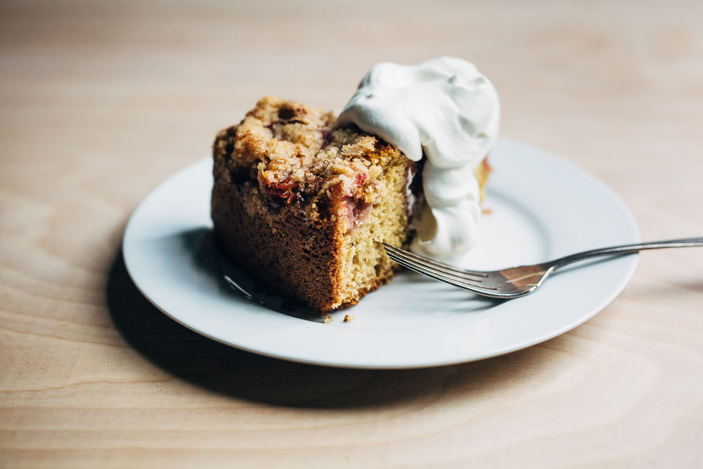 This strawberry crumb cake has a toothsome whole wheat crumb and is topped with ripe strawberries, a perfectly salty-sweet crumb topping, and unsweetened whipped cream. 