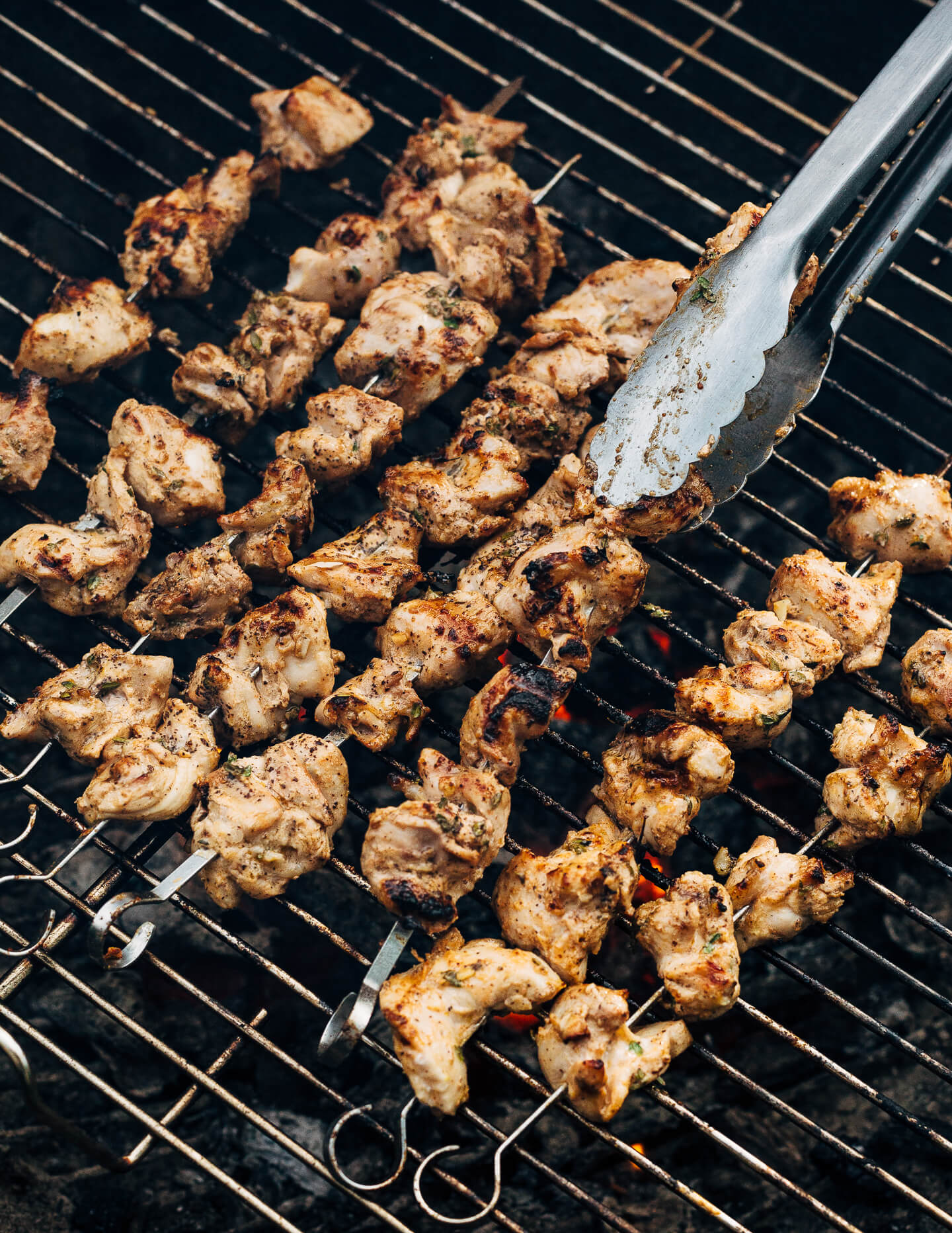 Deliciously tender lemon- and yogurt-marinated grilled chicken kebobs make for a vibrant summer cookout. The grilled chicken skewers are served alongside grilled flatbreads, tzatziki, and an herbed salad made with grilled zucchini, tomato, and red onion.