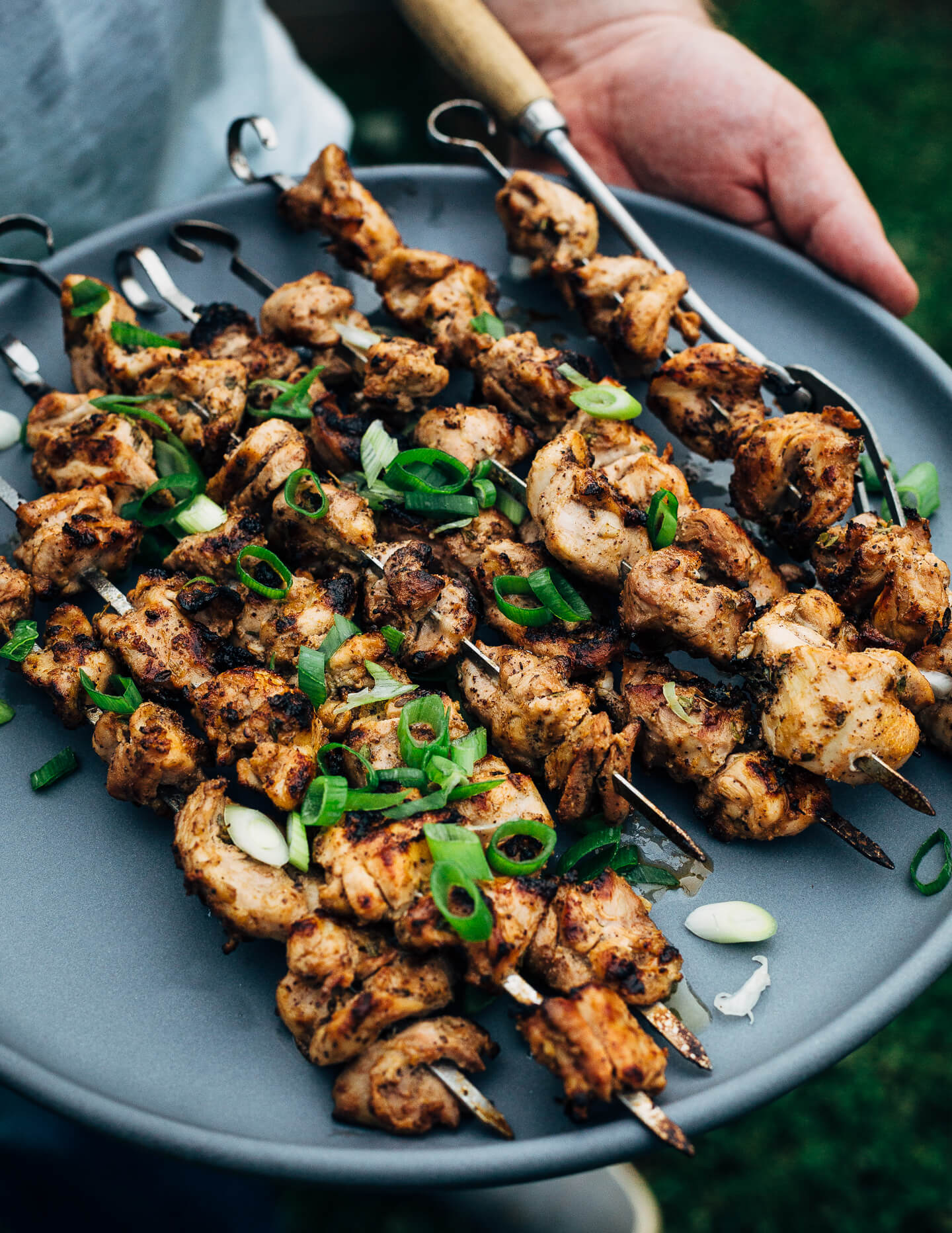 Deliciously tender lemon- and yogurt-marinated grilled chicken kebobs make for a vibrant summer cookout. The grilled chicken skewers are served alongside grilled flatbreads, tzatziki, and an herbed salad made with grilled zucchini, tomato, and red onion.