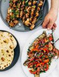 Deliciously tender lemon- and yogurt-marinated grilled chicken kebobs make for a vibrant summer cookout. The grilled chicken skewers are served alongside grilled flatbreads, tzatziki, and an herbed salad made with grilled zucchini, tomato, and red onion.