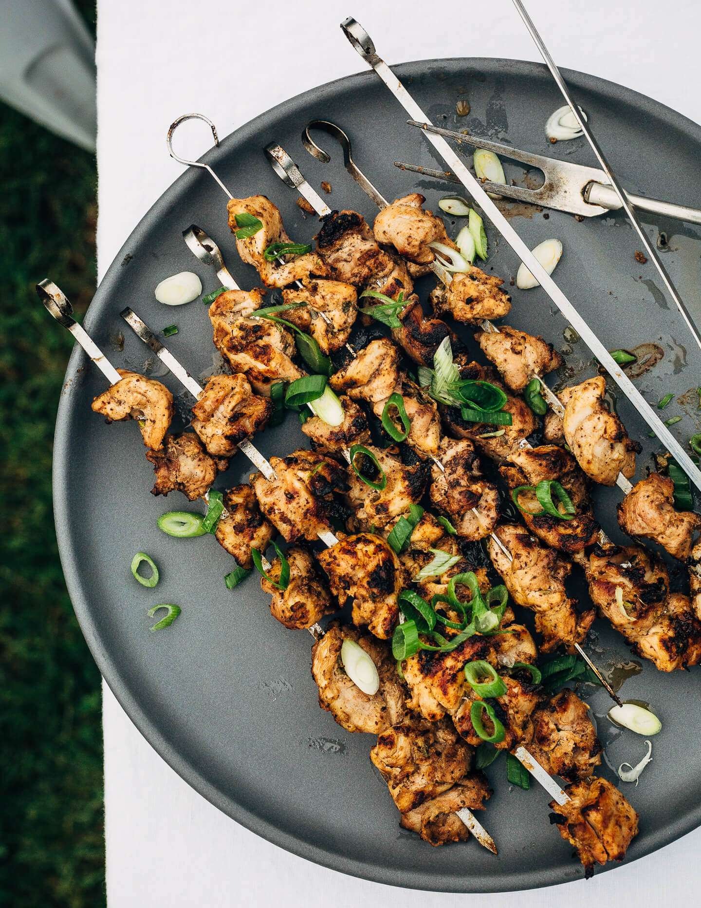 Deliciously tender lemon- and yogurt-marinated grilled chicken kebobs make for a vibrant summer cookout. The grilled chicken skewers are served alongside grilled flatbreads, tzatziki, and an herbed salad made with grilled zucchini, tomato, and red onion.