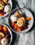 A summery cherry and peach cornmeal cobbler that pairs the sweetness of ripe summer stone fruits with a tender, faintly sweet, cornmeal biscuit topping. 