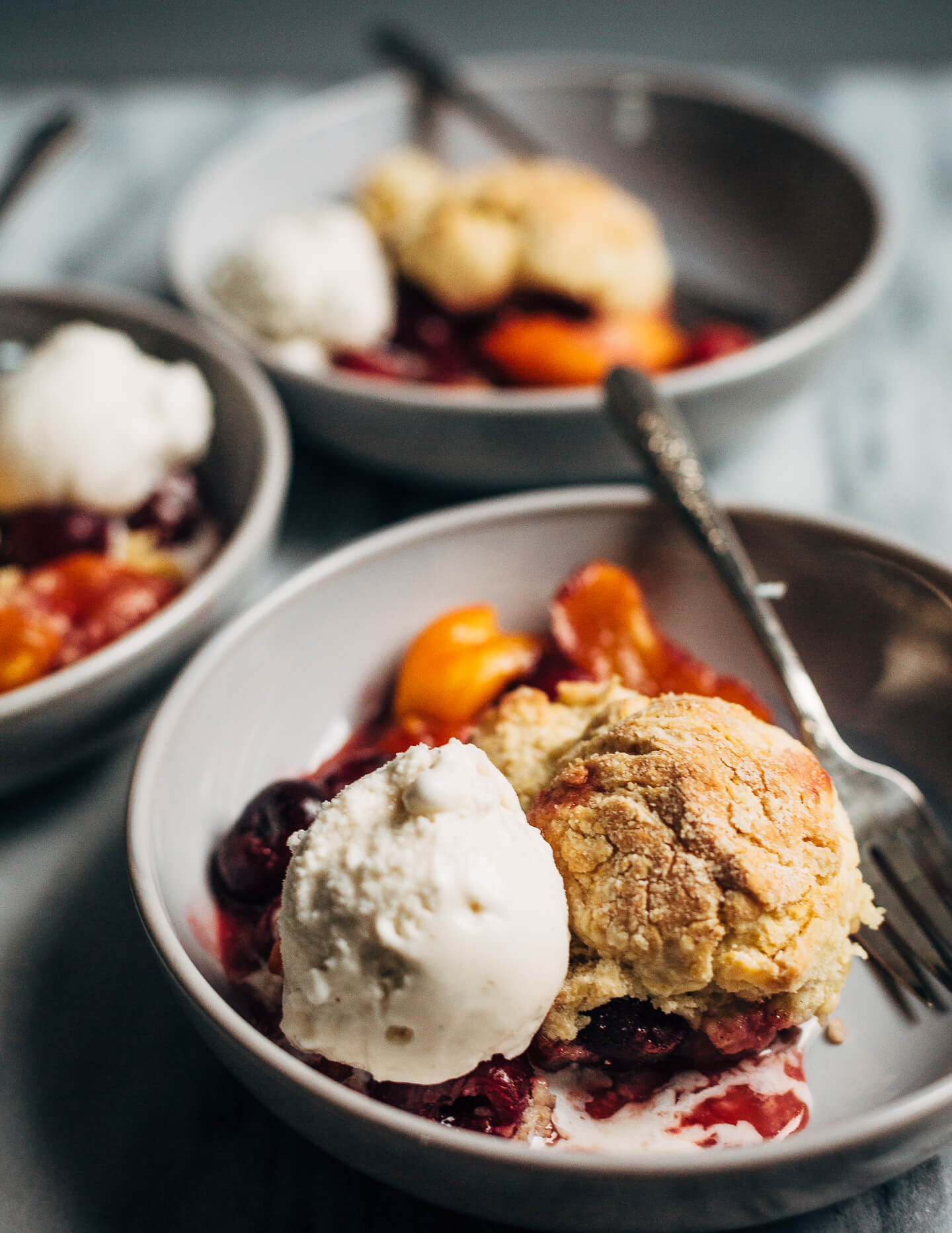 A summery cherry and peach cornmeal cobbler that pairs the sweetness of ripe summer stone fruits with a tender, faintly sweet, cornmeal biscuit topping. 